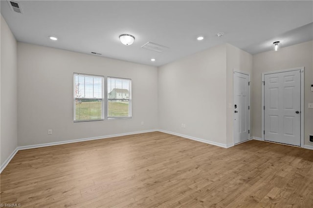 spare room featuring light hardwood / wood-style flooring