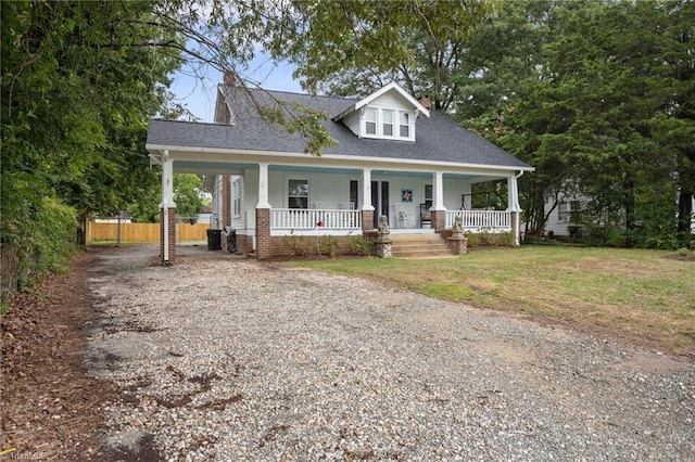 view of front of house featuring covered porch and a front yard