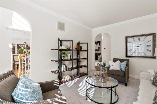 living room with a notable chandelier, light colored carpet, and crown molding