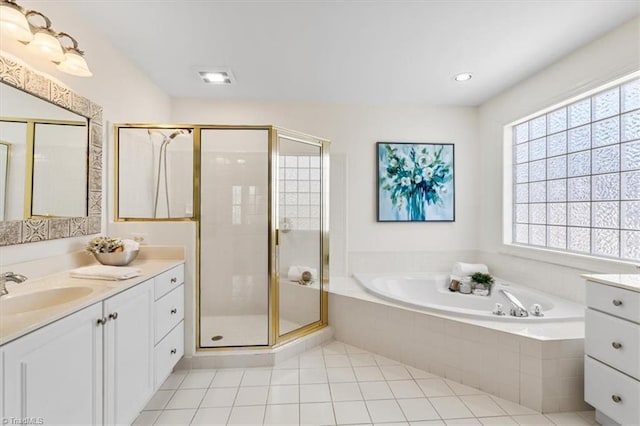 bathroom with plus walk in shower, vanity, and tile patterned floors