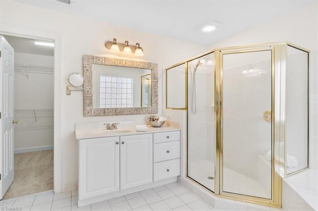 bathroom with tile patterned floors, vanity, and an enclosed shower