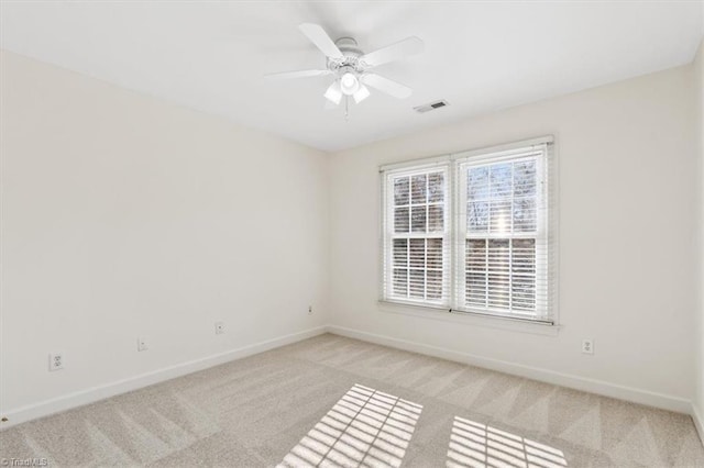 carpeted empty room featuring ceiling fan