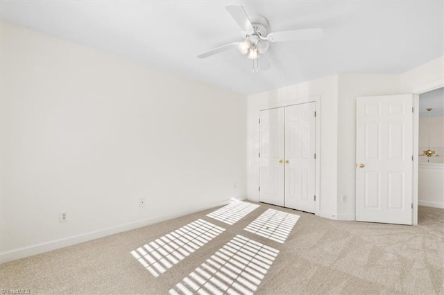 unfurnished bedroom with ceiling fan, a closet, and light carpet