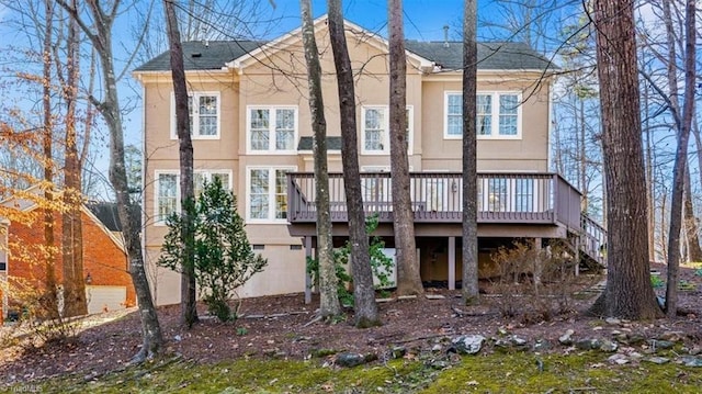 rear view of property with a wooden deck