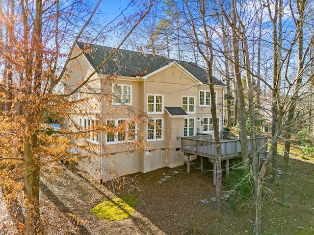 rear view of property with a wooden deck