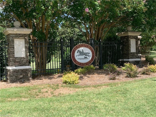 community / neighborhood sign with a yard