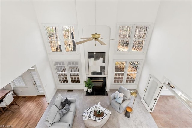 living room featuring a towering ceiling and ceiling fan