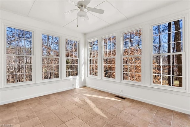 unfurnished sunroom featuring ceiling fan