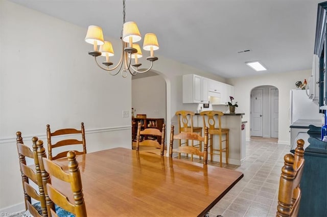 2105 Rosemont Dr, Colfax, NC 27235 - dining area with arched walkways and a chandelier