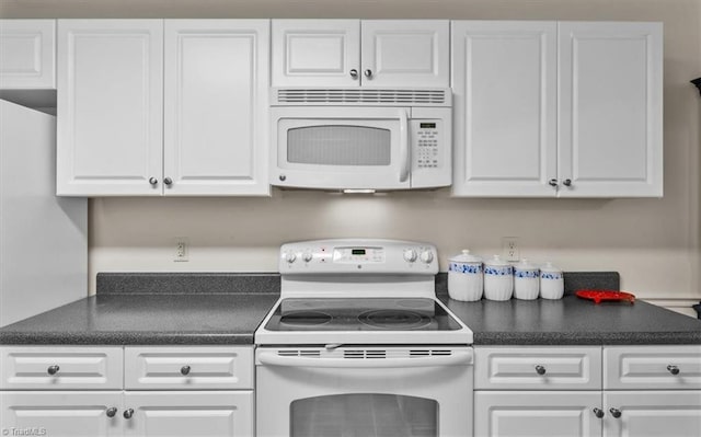 2105 Rosemont Dr, Colfax, NC 27235 - kitchen featuring white appliances, white cabinets, and dark countertops