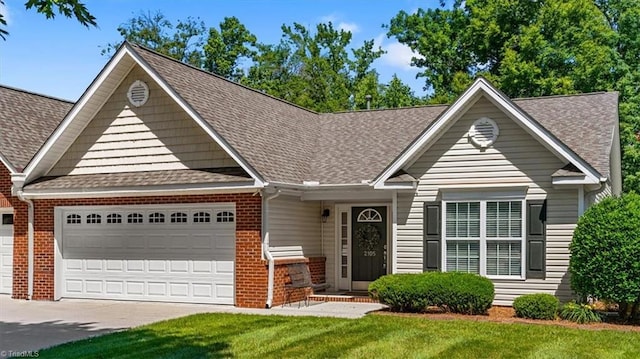 2105 Rosemont Dr, Colfax, NC 27235 - view of front of property featuring a garage, brick siding, and a shingled roof
