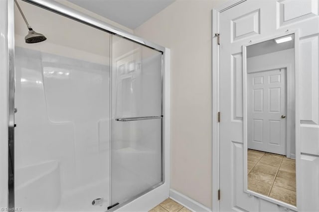 2105 Rosemont Dr, Colfax, NC 27235 - bathroom featuring a stall shower, tile patterned flooring, and baseboards