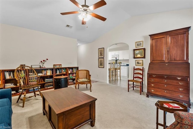 2105 Rosemont Dr, Colfax, NC 27235 - living room with vaulted ceiling, a ceiling fan, arched walkways, light carpet, and baseboards