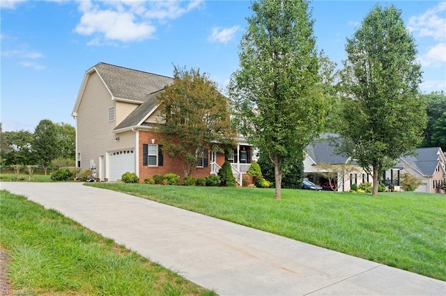 view of front of property featuring a front yard and a garage