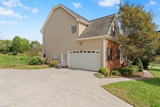 view of property exterior with a lawn and a garage