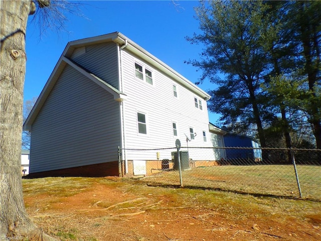 view of property exterior with a yard, cooling unit, and fence