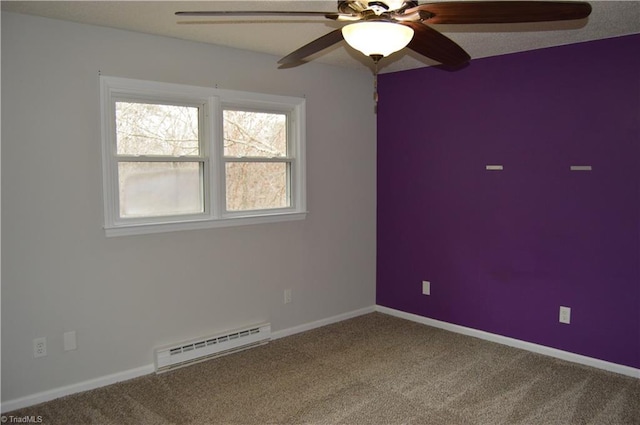 carpeted spare room with a ceiling fan, baseboards, and baseboard heating