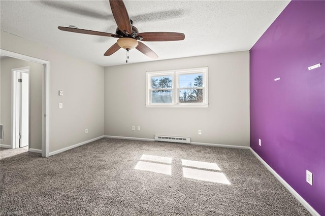 spare room with a baseboard radiator, a textured ceiling, and carpet