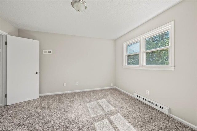 unfurnished room featuring carpet, baseboards, visible vents, and baseboard heating