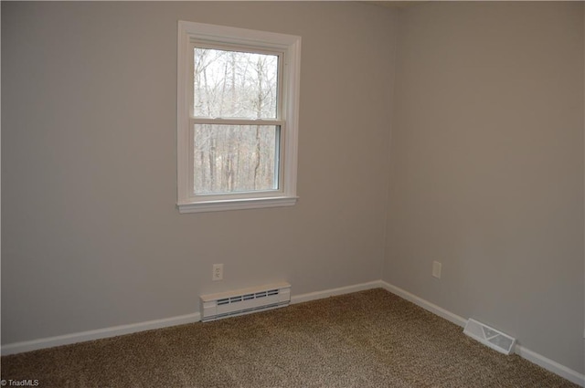 carpeted spare room featuring a baseboard radiator, visible vents, and baseboards