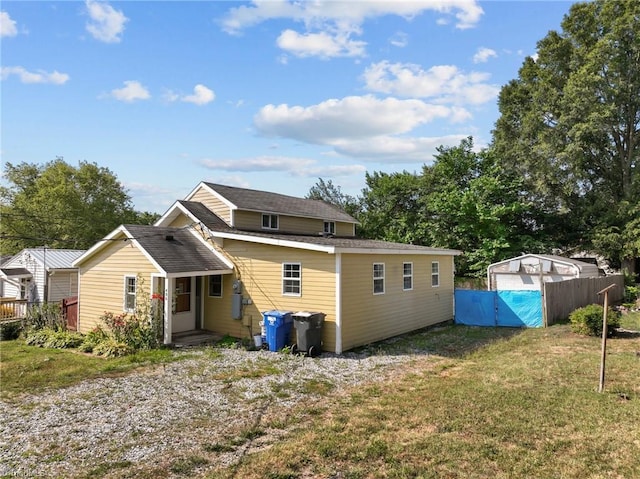 back of property featuring a lawn