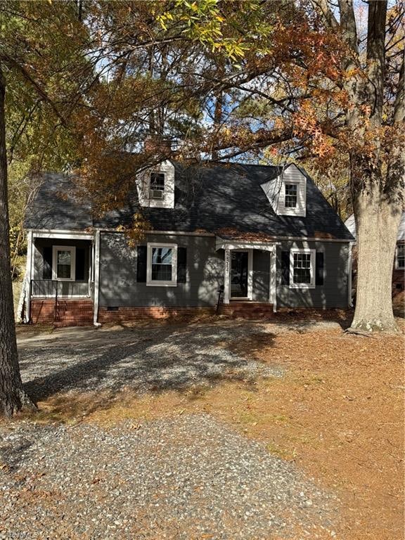 new england style home with a porch