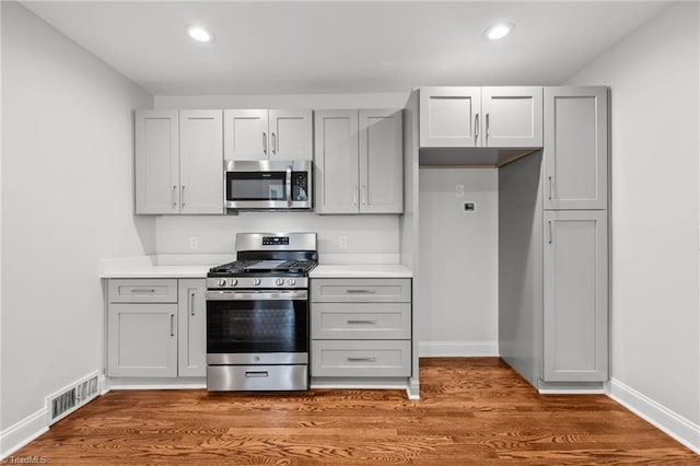 kitchen featuring gray cabinets, dark wood-type flooring, and appliances with stainless steel finishes