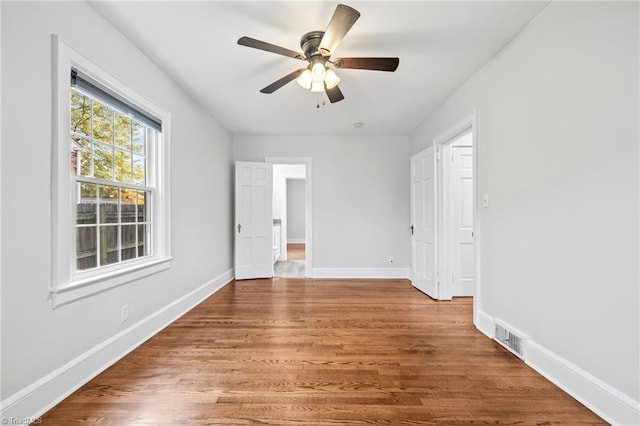 spare room with wood-type flooring and ceiling fan