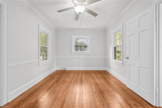 empty room with light hardwood / wood-style floors, ceiling fan, and crown molding