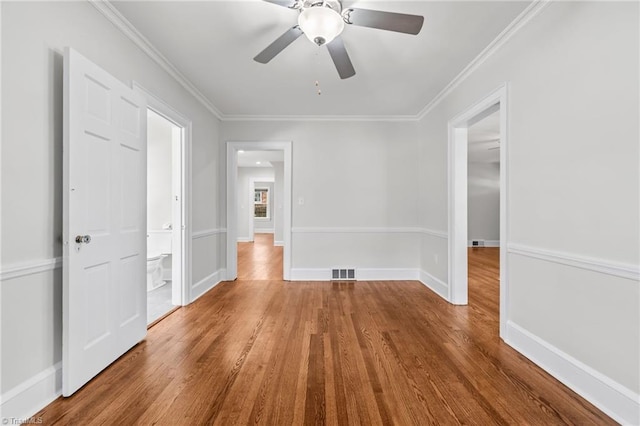 empty room featuring hardwood / wood-style flooring, ceiling fan, and ornamental molding