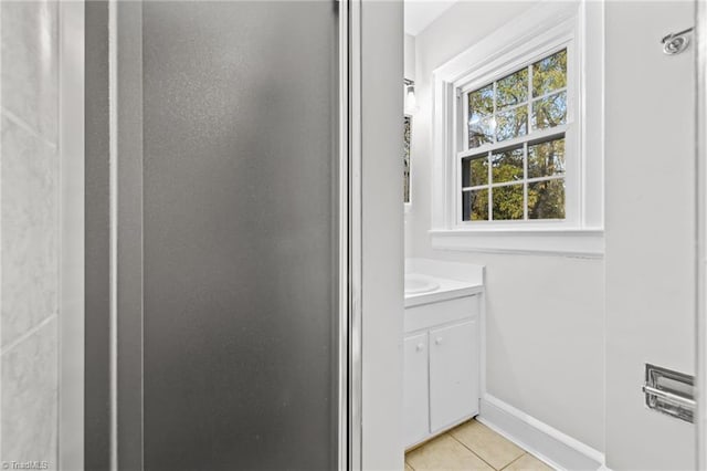 bathroom with tile patterned floors and vanity