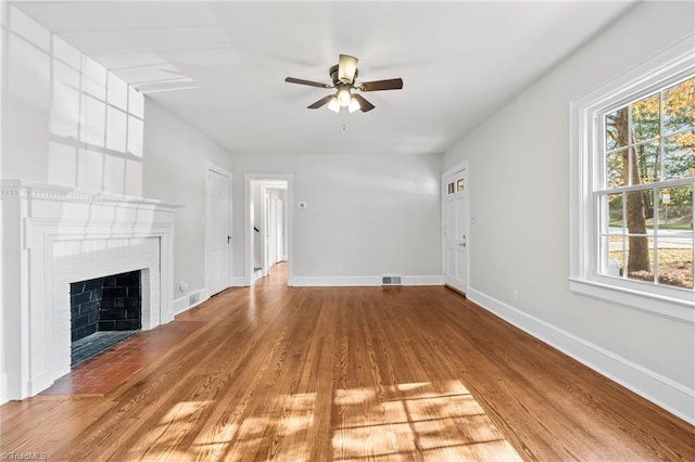 unfurnished living room featuring a fireplace, hardwood / wood-style floors, and ceiling fan