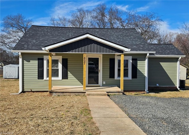 bungalow featuring a porch and roof with shingles