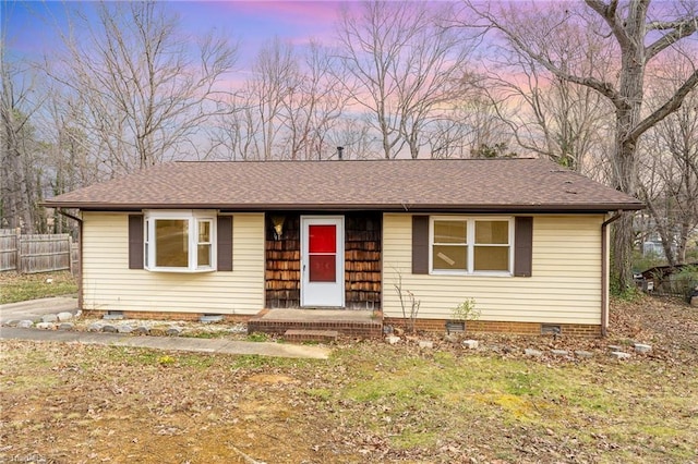 ranch-style house with crawl space, roof with shingles, and fence