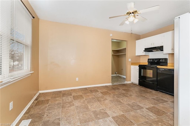 kitchen with black appliances, under cabinet range hood, white cabinets, light countertops, and baseboards