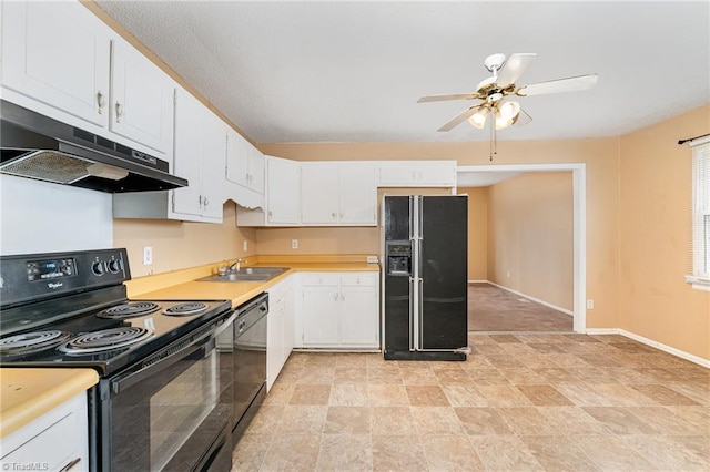 kitchen with under cabinet range hood, black appliances, a sink, and light countertops