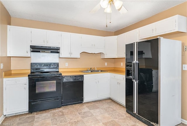 kitchen with black appliances, under cabinet range hood, a sink, white cabinets, and light countertops