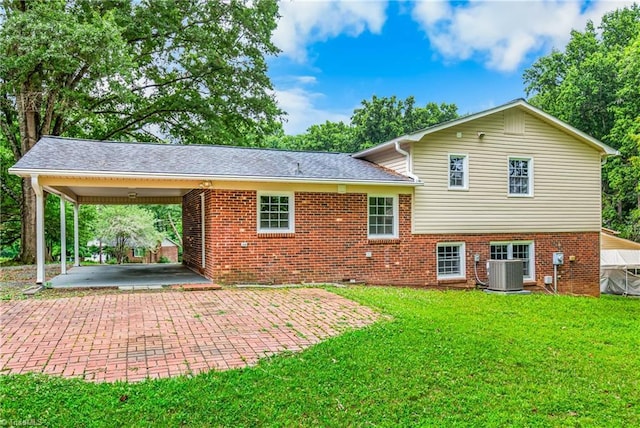 911 Chuppway Ct, Winston-Salem, NC 27106 - back of house with a yard, brick siding, an attached carport, and decorative driveway