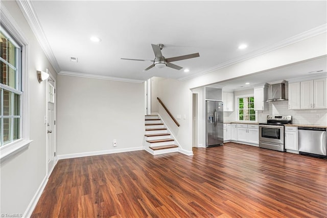 911 Chuppway Ct, Winston-Salem, NC 27106 - kitchen featuring stainless steel appliances, wall chimney range hood, dark wood-type flooring, ornamental molding, and ceiling fan