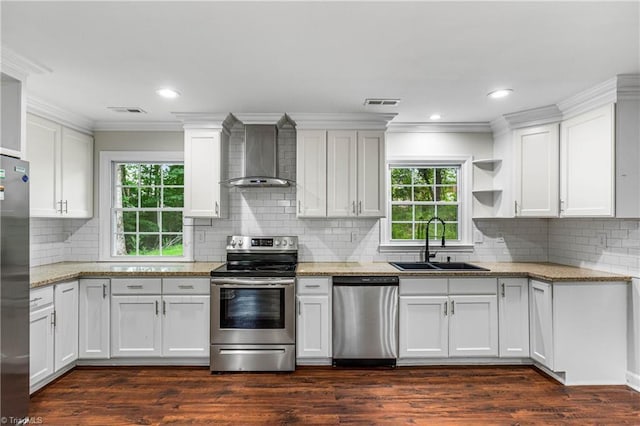 911 Chuppway Ct, Winston-Salem, NC 27106 - kitchen featuring appliances with stainless steel finishes, wall chimney exhaust hood, white cabinets, plenty of natural light, and crown molding