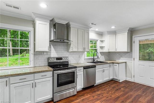 911 Chuppway Ct, Winston-Salem, NC 27106 - kitchen with appliances with stainless steel finishes, wall chimney exhaust hood, healthy amount of natural light, white cabinets, and crown molding