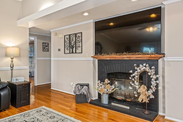 interior space featuring a fireplace, wood-type flooring, and ornamental molding