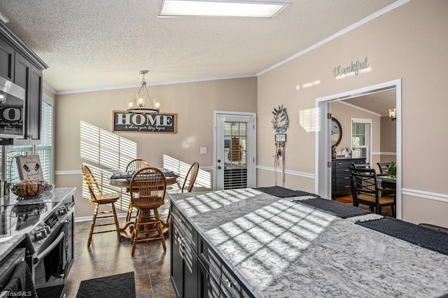 kitchen with a chandelier, appliances with stainless steel finishes, decorative light fixtures, and crown molding