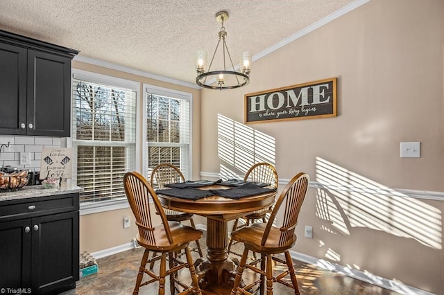 dining area with ornamental molding, a textured ceiling, and a notable chandelier