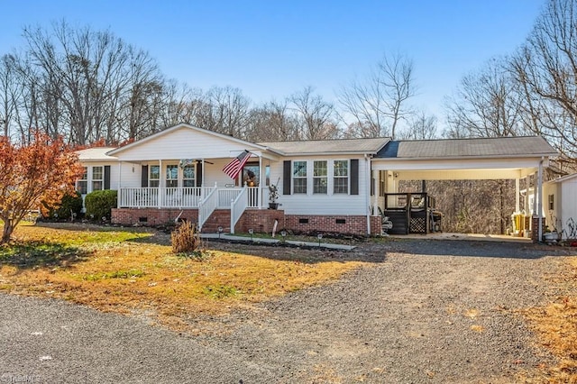 ranch-style home with a porch and a carport