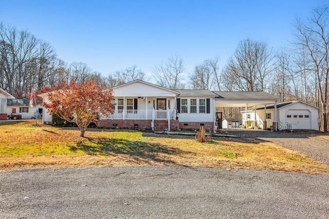 ranch-style home featuring covered porch, a front lawn, and a carport