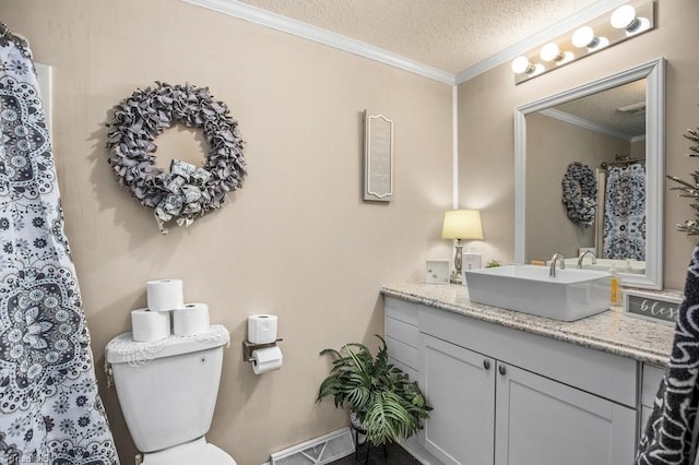 bathroom featuring toilet, crown molding, a textured ceiling, and vanity