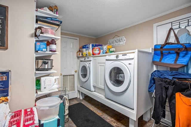 clothes washing area featuring ornamental molding, a textured ceiling, and independent washer and dryer