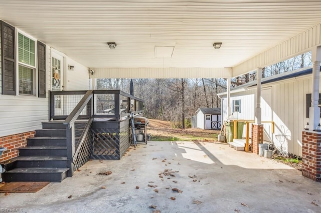 view of patio with a grill and a storage shed