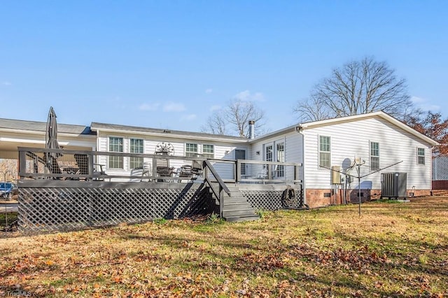 back of property featuring central AC unit, a lawn, and a wooden deck